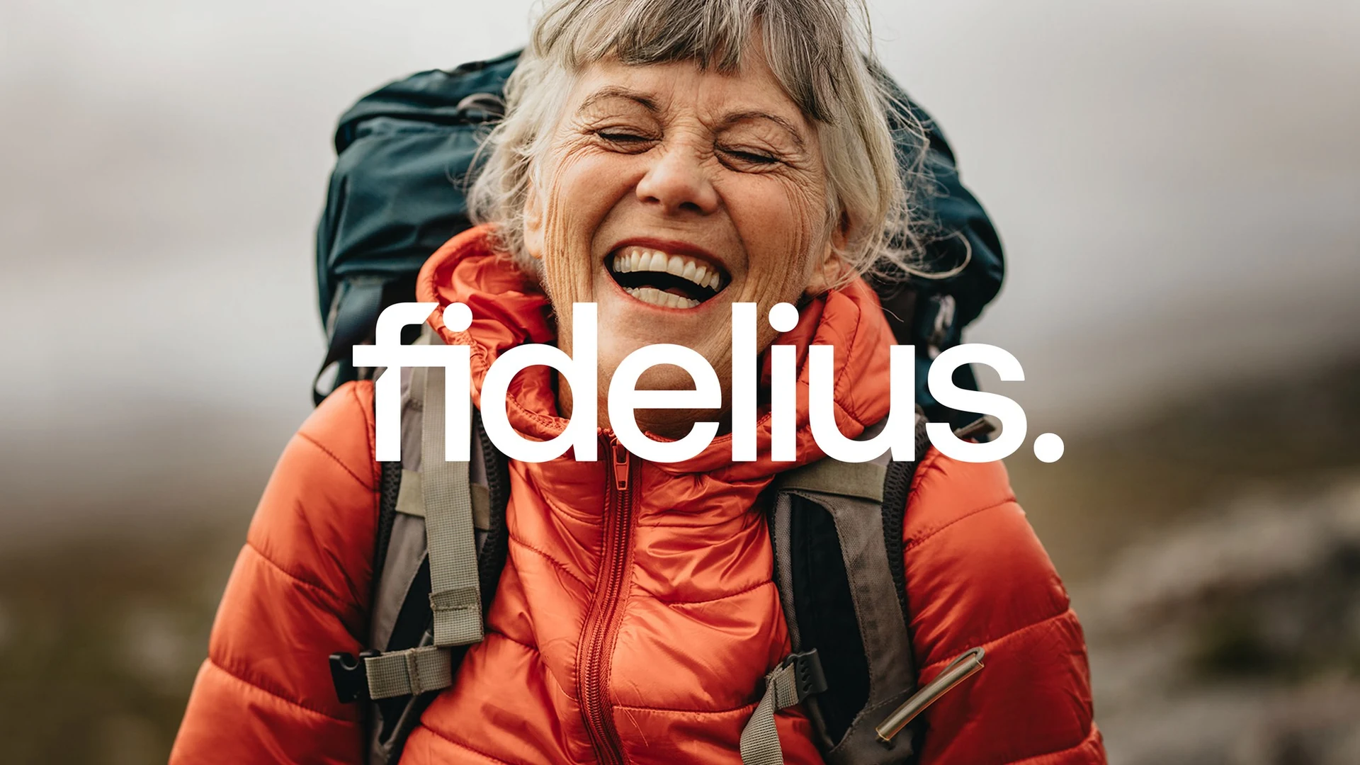 Fidelius brand identity with a white wordmark over a photograph of a smiling hiker